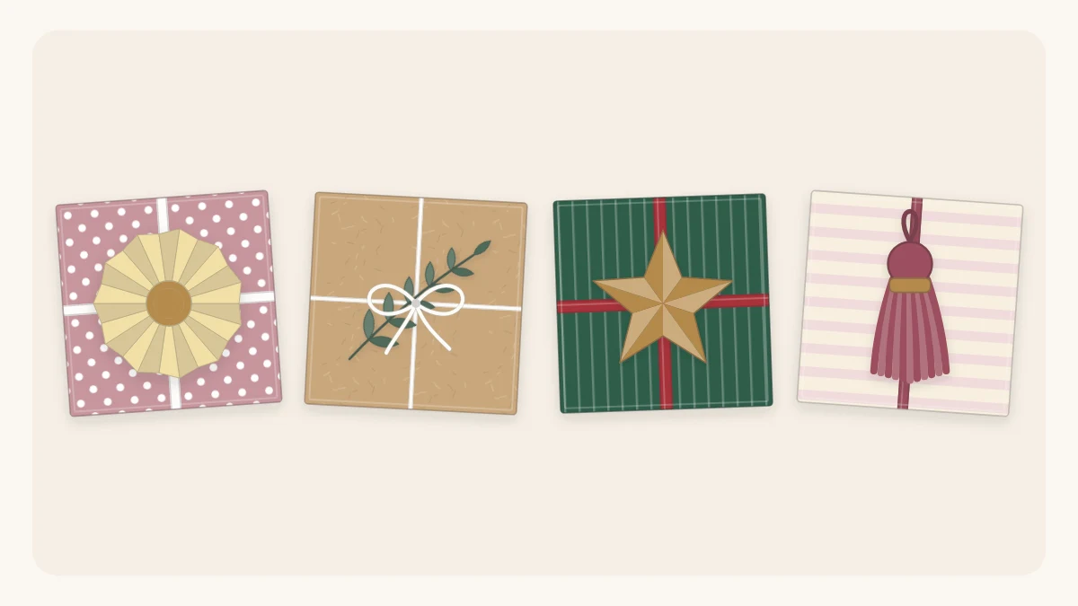Four small wrapped gifts from above topped with a paper rosette, a greenery sprig, a paper star and a tassel