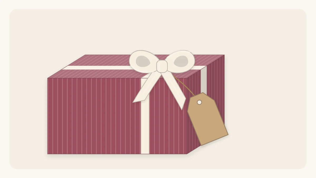 A wrapped gift with a tag tied into the knot of the bow, hanging at an angle over the corner of the box