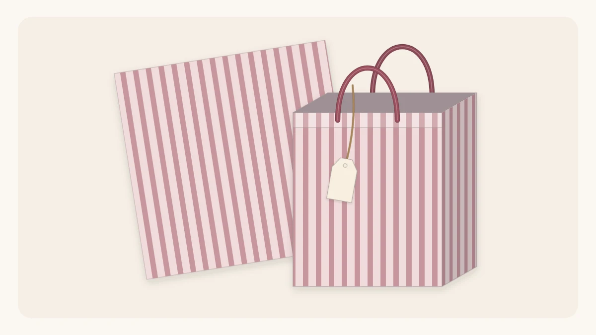 A handmade striped paper gift bag with ribbon handles standing upright with a tag tied to one handle