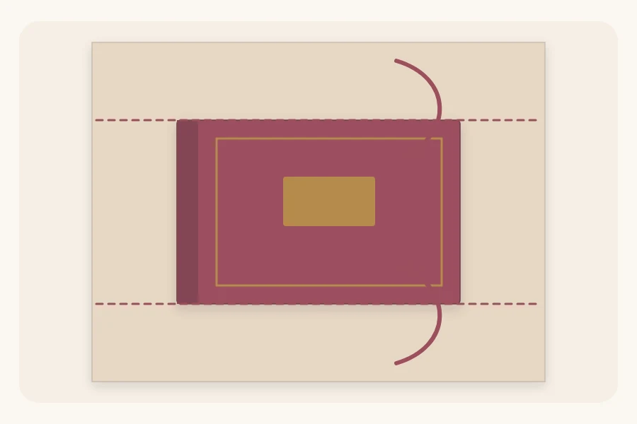 A book on a sheet of paper from above with dashed lines marking the folds