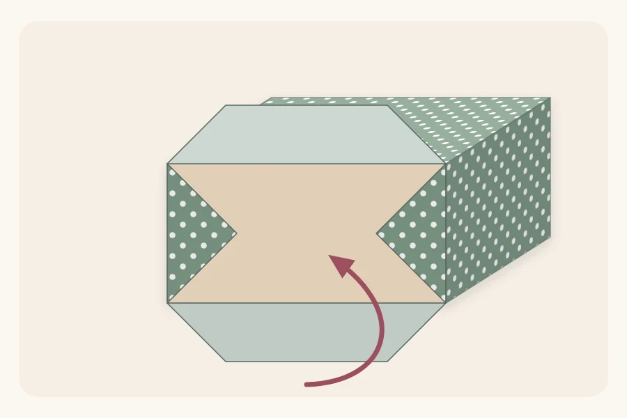 Close view of a box end with side flaps folded in and the bottom flap folding up