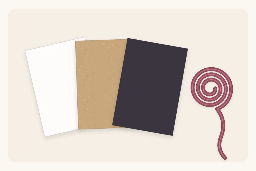 Three paper swatches in white, kraft and charcoal beside one coiled accent ribbon