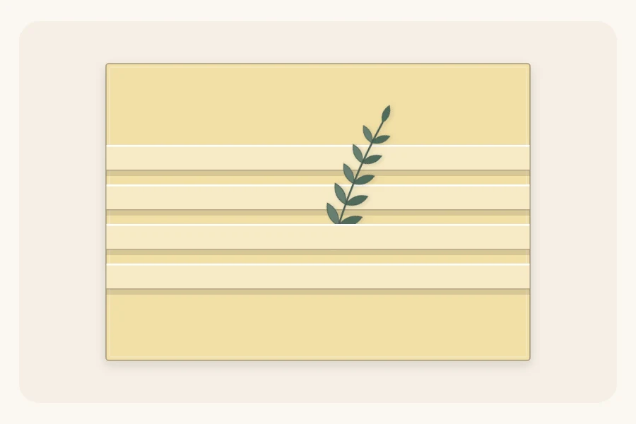 A wrapped box with horizontal pleats across the top and a small sprig tucked into one